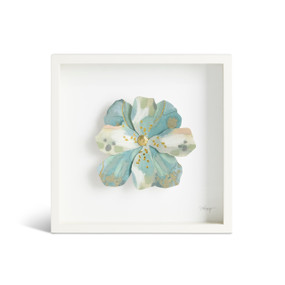Front view of a white square shadow box. There is a large sculpted blue and white flower at the center,