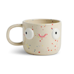 Front facing view of a cream colored character mug that  has pink and blue speckles. The mug's handle is to the left. The mug is named Tori BFF and has a smiling face on her front.