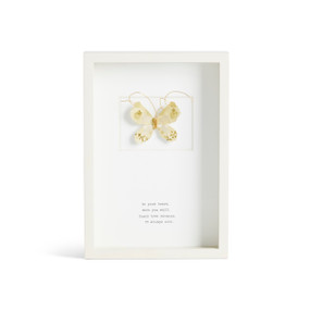 Front facing view of a white rectangular shadow box. At the top is a sculpted pale yellow butterfly with brown markings. "In your heart. With you still. Their love remains. It always will." is printed in typeface centered at the bottom.