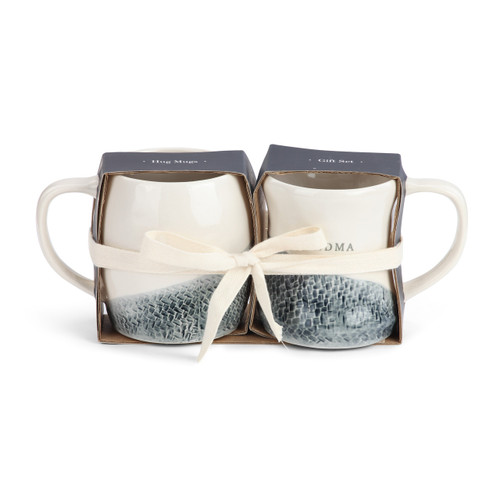 two blue and white ceramic patterned mugs wrapped in a gift set with a white ribbon