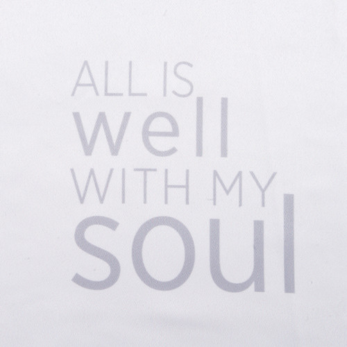Close up detailed view of the saying "All is Well with my Soul" on a white pillowcase.