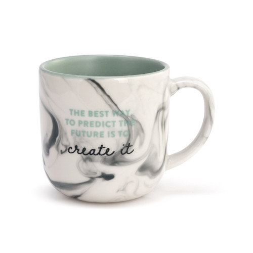 A white ceramic mug with a marbleized look on the outside and a green interior. The mug says "The best way to predict the future is to create it".
