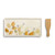 An ivory appetizer tray with a yellow summer flower print. Placed beside a wooden spatula.