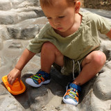 Baby boy wearing Space Dye Sharks Water Shoes in Medium Blue, playing sands