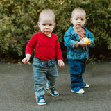 Baby boys wearing Brooks First Kicks in Navy and Joey First Kicks in Navy, facing the camera