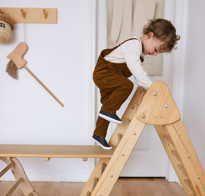 Toddler learning to walk and climb