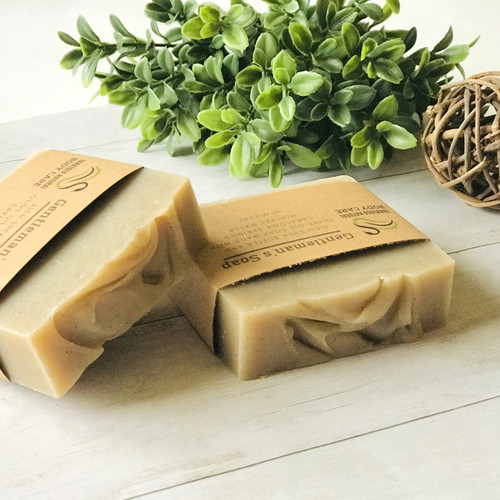 Gentleman’s handmade soap bar sliced in half, neutral beige artisan soap with creamy swirl texture, vegan men’s soap made with olive oil and shea butter.