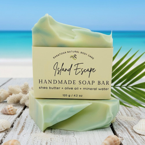 Island Escape handmade soap bar with tropical green swirl, vegan artisan soap styled with seashells and palm leaf, beach-inspired skincare