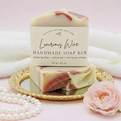 Luxurious Wine handmade soap bar on a gold tray with pearls and a pink flower. Artisan vegan soap with shea butter, olive oil, and mineral water — romantic and luxurious, ideal for bridal gifts or spa-inspired self-care. Luxurious Wine handmade soap bar on a gold tray with pearls and a pink flower. Artisan vegan soap with shea butter, olive oil, and mineral water — romantic and luxurious, ideal for bridal gifts or spa-inspired self-care.