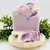 Lilac Bloom handmade soap bar with label, shown in flat lay with sliced purple swirl soap pieces on a white background