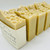 Handmade oatmeal turmeric and honey soap bars with honeycomb texture, crafted with natural ingredients and mineral water.