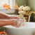 A close-up of a person's hands washing with the "Crisp Apple Sage" soap bar, which is covered in thick white lather. The scene is set at a sink with a brass faucet. In the background, there's a window with a single red maple leaf and a basket of white pumpkins on the sill, emphasizing the autumn theme. A close-up of a person's hands washing with the "Crisp Apple Sage" soap bar, which is covered in thick white lather. The scene is set at a sink with a brass faucet. In the background, there's a window with a single red maple leaf and a basket of white pumpkins on the sill, emphasizing the autumn theme.
