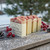 Winter Berry handmade soap bars by Saratoga Natural Body Care displayed outdoors on snowy wood with red berries and pinecones — festive winter skincare gift.