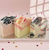 Artisan Valentine’s Day soap trio in pink, cream, and black swirl designs displayed on a pink background with scattered heart confetti.