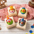 Carnival Suds handmade soap bars with fun rubber duck toys in carnival costumes, arranged on red striped fabric for a bright gift-ready display.