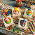 Carnival Suds handmade novelty soap bars with colorful carnival duck toys, displayed on a playful circus-themed background with pastel candy props.