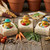 Garden Suds handmade novelty soap bars with garden rubber duck toys, carrots, tomatoes, herbs, seed packets, and rustic farmhouse gardening display.