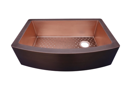 Arched Single Bowl Copper Farmhouse Sink with Grate: A handcrafted copper farmhouse sink that transforms spaces with 16-gauge copper and conversation-starting presence. Custom-made with Artisanal Craftsmanship to be the centerpiece of your kitchen or bathroom.