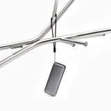 A compact black Bluetooth speaker hanging from a metal frame, featuring a sleek design and a strap.