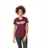 A maroon women's short sleeve tech tee with a logo on the chest and one on the sleeve.