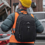 A black High Sierra Extension Backpack with multiple compartments, worn by a person in a reflective vest and hard hat.