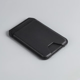 A black magnetic wallet with a slim design, featuring a phone stand and a branding logo on the surface.