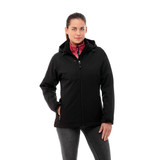 A woman poses in a black insulated softshell jacket with a pink interior, featuring a logo on the sleeve.