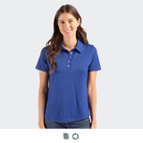 A woman wearing a blue polo shirt with a collar and buttons, standing against a neutral background.