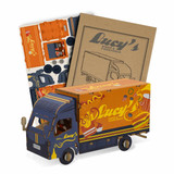 A small wooden model of a truck in blue and orange, with accompanying cardboard pieces for assembly.