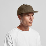 A wool cap in a brown hue, featuring a flat brim and a fitted design, displayed on a model wearing a white shirt.