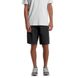 Active training shorts in black, featuring a logo, styled with a grey T-shirt and grey trainers.