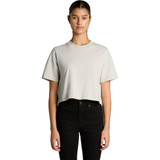 A cropped, heavy faded t-shirt in light grey, displayed on a model with black jeans. The shirt has a logo.