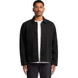 A man wearing a black canvas chore jacket with front pockets, styled over a white t-shirt.