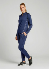 A woman wearing a navy blue unisex mid-layer top with long sleeves and matching pants, standing against a plain background.