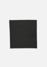 A piece of dark green fabric with a smooth texture and scalloped edges, featuring a subtle sheen.