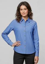 A women's long sleeve button-up shirt in light blue, featuring a collared neckline and a single pocket.
