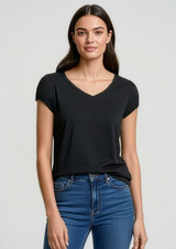 A woman wearing a black short sleeve V-neck t-shirt paired with blue jeans, featuring a subtle logo.
