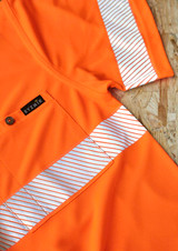 An orange short sleeve polo shirt featuring segmented reflective tape and a logo. The material appears breathable and mesh-like.