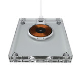 A wireless charger with a clear acrylic body and a circular copper charging pad. It includes a white charging cable.