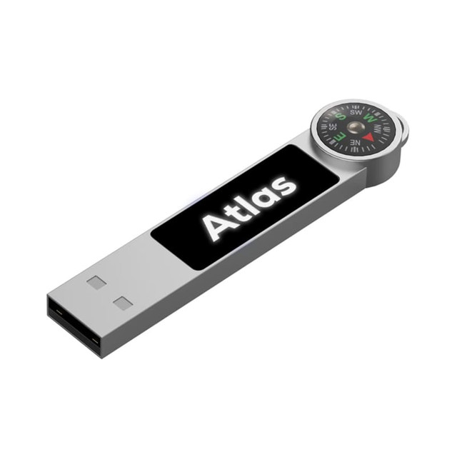 A silver LED flash drive with a compass feature and a branding logo.