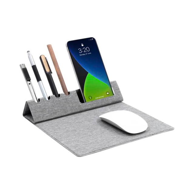A grey foldable mouse pad with slots for pens and a phone, featuring a white mouse on the surface.