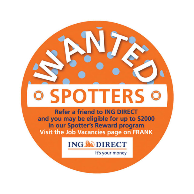 An orange circular promotional sticker with white text and a logo, featuring polka dots and a "Wanted" theme.