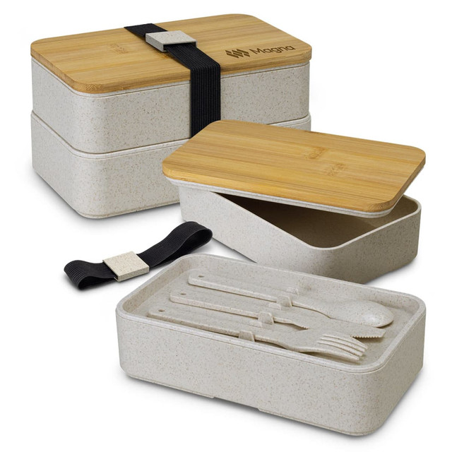 A stackable lunch box in a light beige colour with bamboo lid, featuring cutlery and a strap for secure closure.