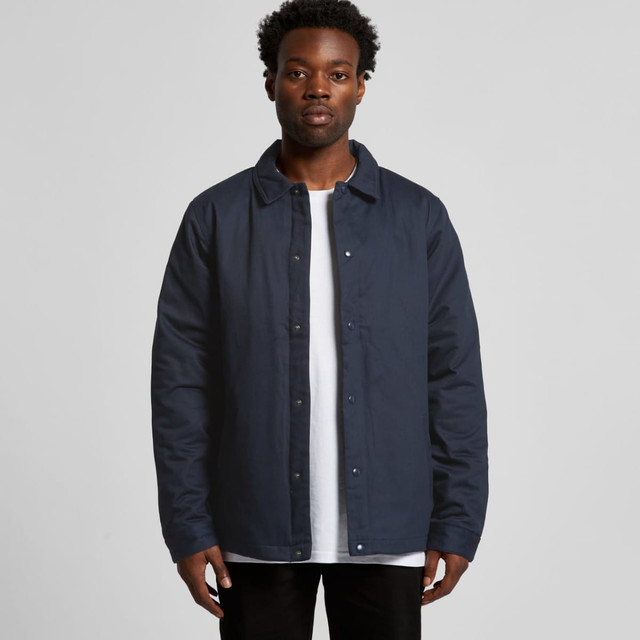 A dark navy work jacket with a button-up front and a classic collar on a model. Contains a logo on the chest.