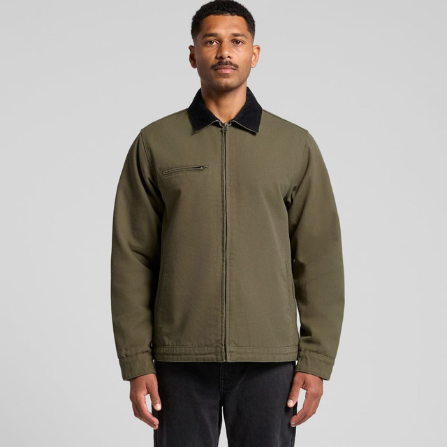 A man wearing a green Canvas Cord Collar Jacket with a black collar, featuring a front zip and a chest pocket.