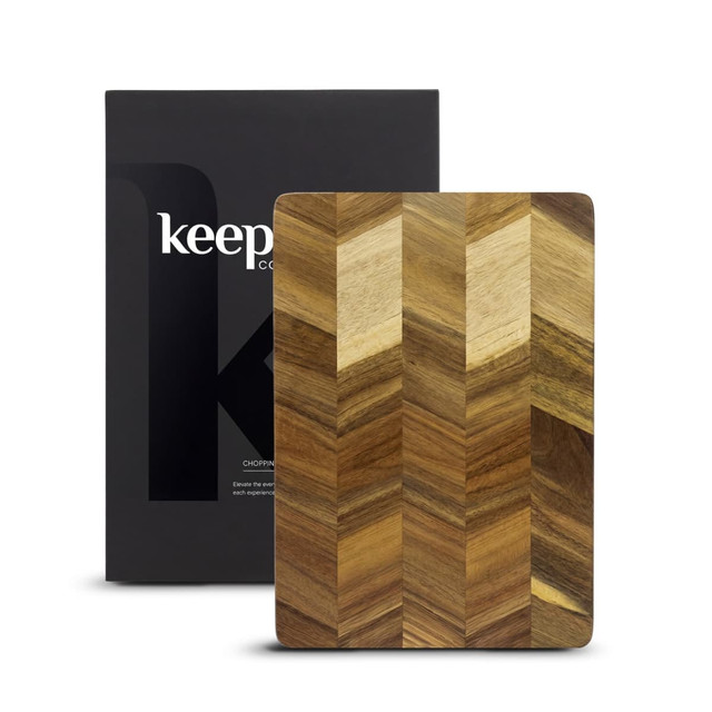 A wooden chopping board with a chevron pattern, packaged in a branded box.