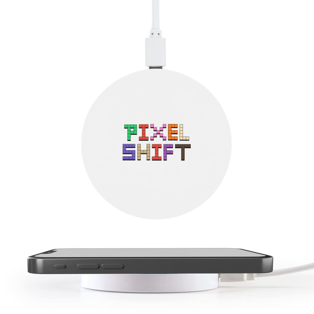 A round white wireless charger with a logo on top, positioned near a smartphone on a white surface.