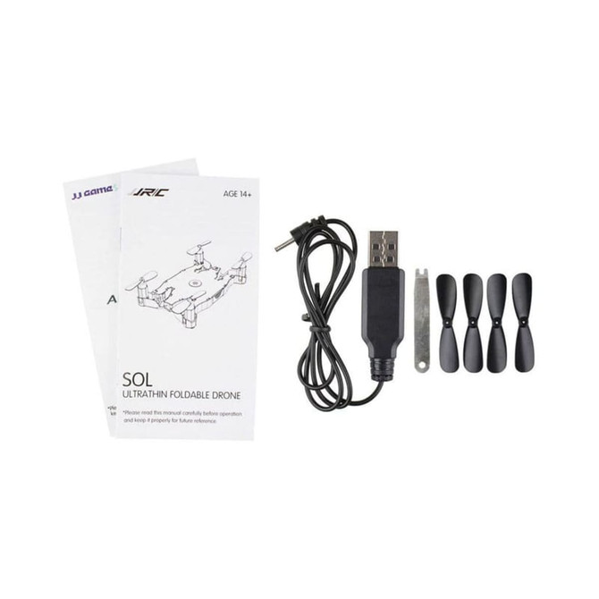 A foldable drone in black with a USB charging cable, extra propellers, and a user manual.