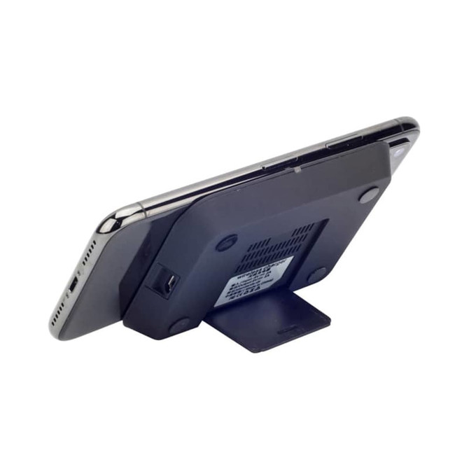 A black wireless charger stand with a mobile phone positioned upright on it, featuring a branding logo.
