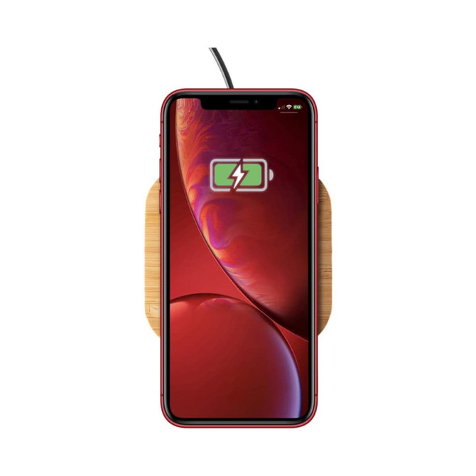 A wireless bamboo fast charger with a red smartphone displaying a charging symbol. The charger has a natural wood finish.